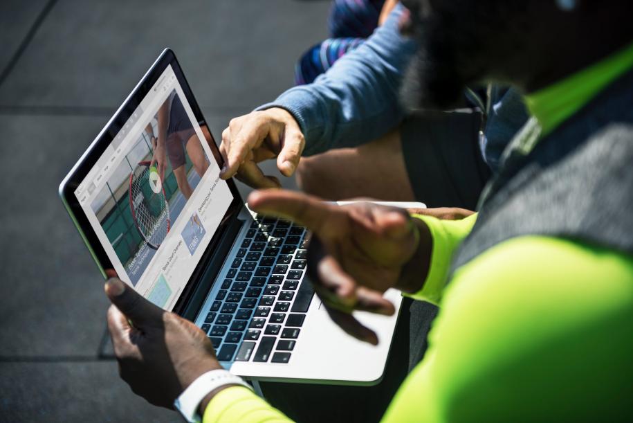men playing video on laptop